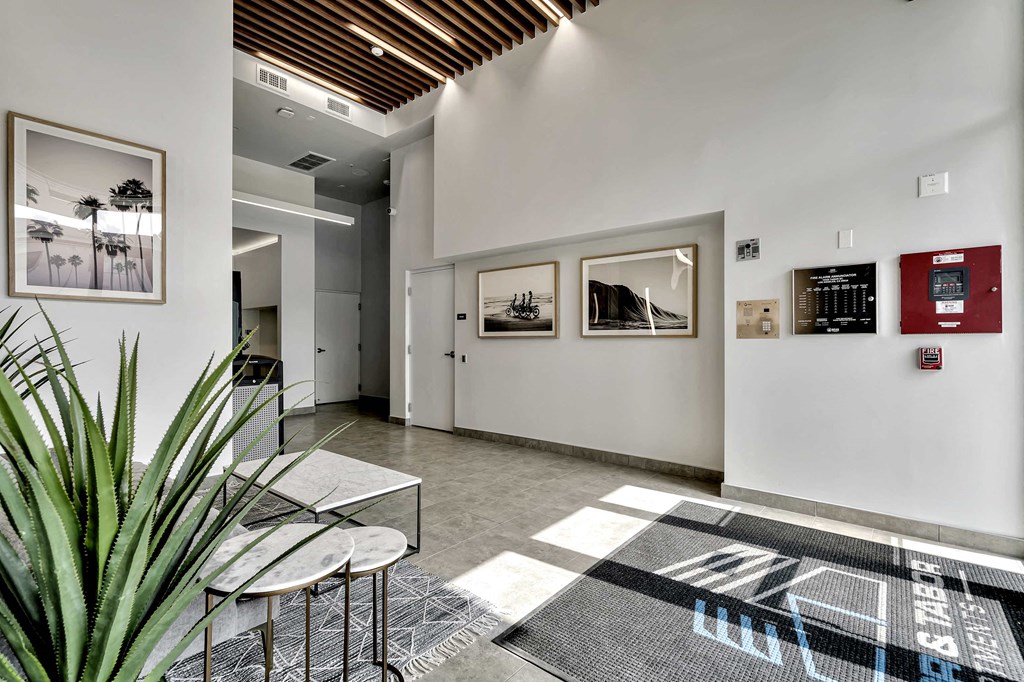 the lobby of a building with a table and chairs