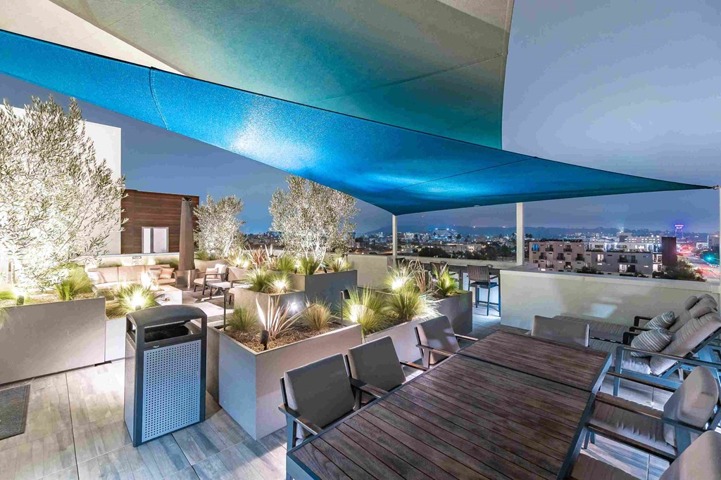 a rendering of a rooftop terrace with a table and chairs