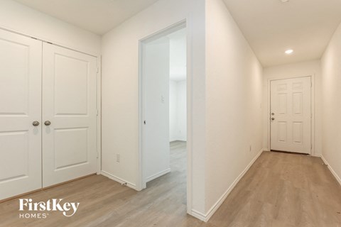 a bedroom with two closets and a door to a hallway