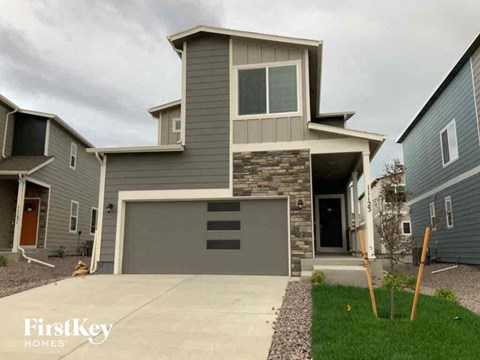 a house with a garage and a driveway in front of it