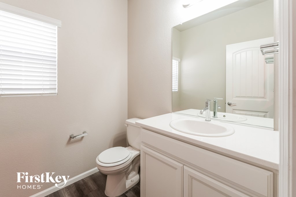 A white bathroom with a toilet and sink.