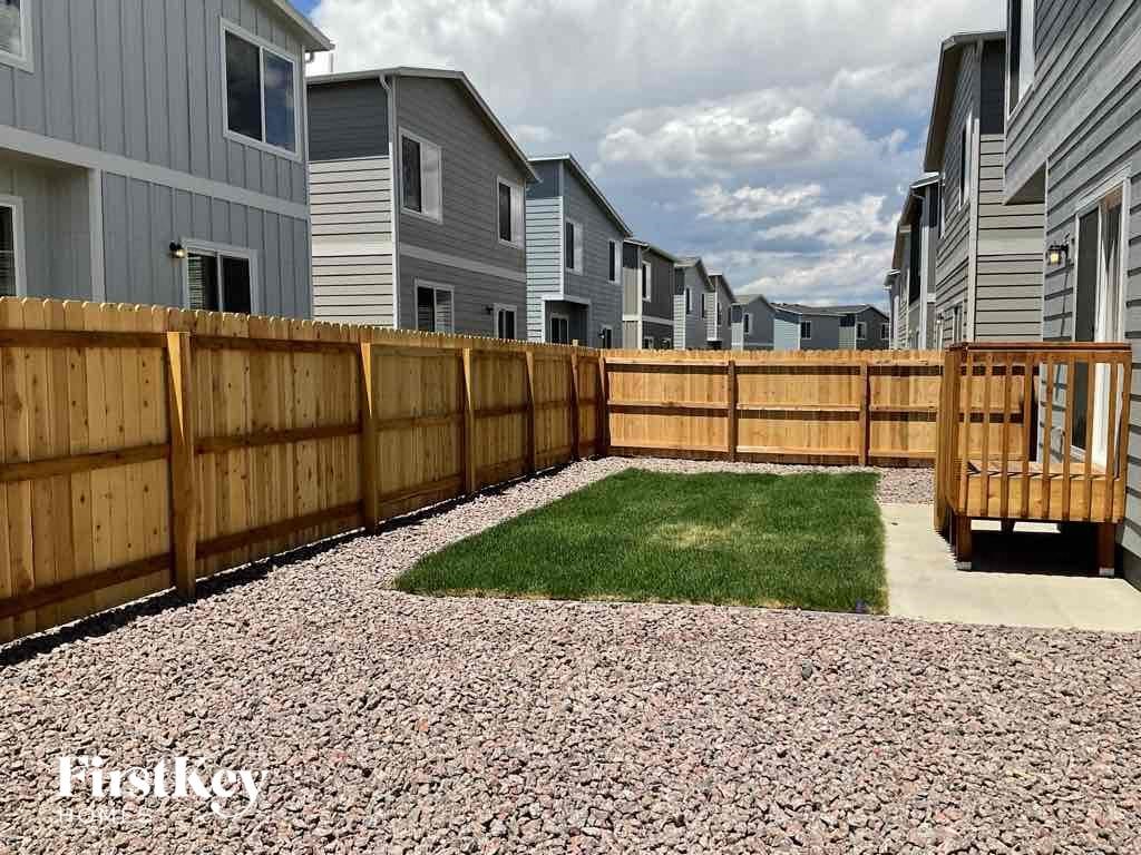 a wooden fence in front of a row of houses