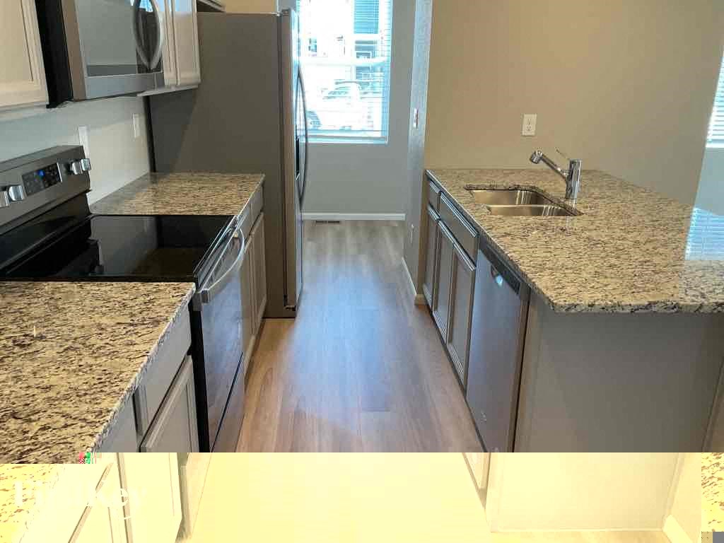 a kitchen with granite counter tops and stainless steel appliances