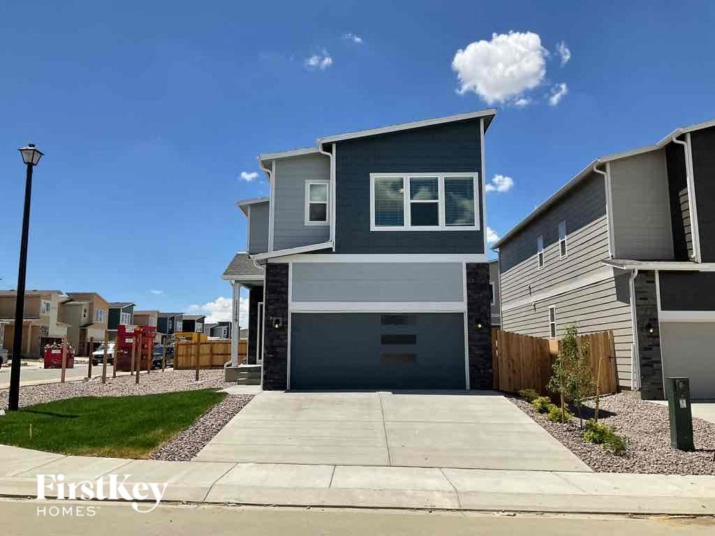 a blue house with a garage and a driveway