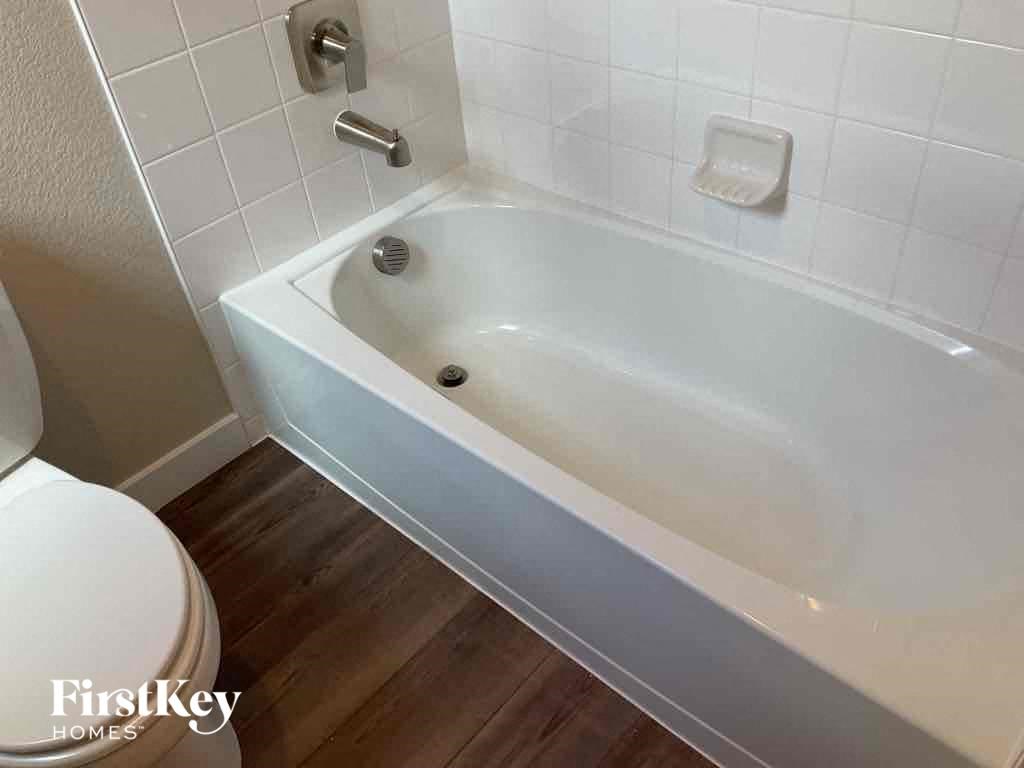 a small white bath tub in a bathroom with a toilet