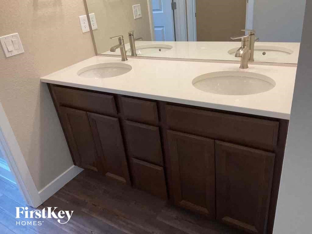 a bathroom with two sinks and a mirror