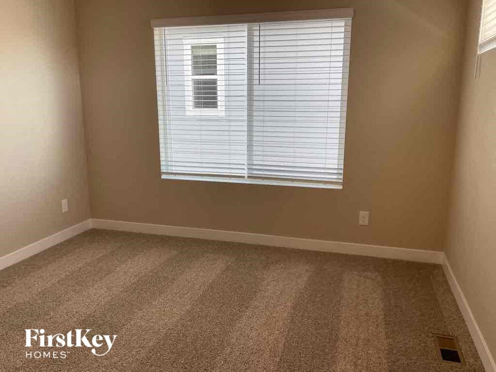 a room with a window and a carpeted floor