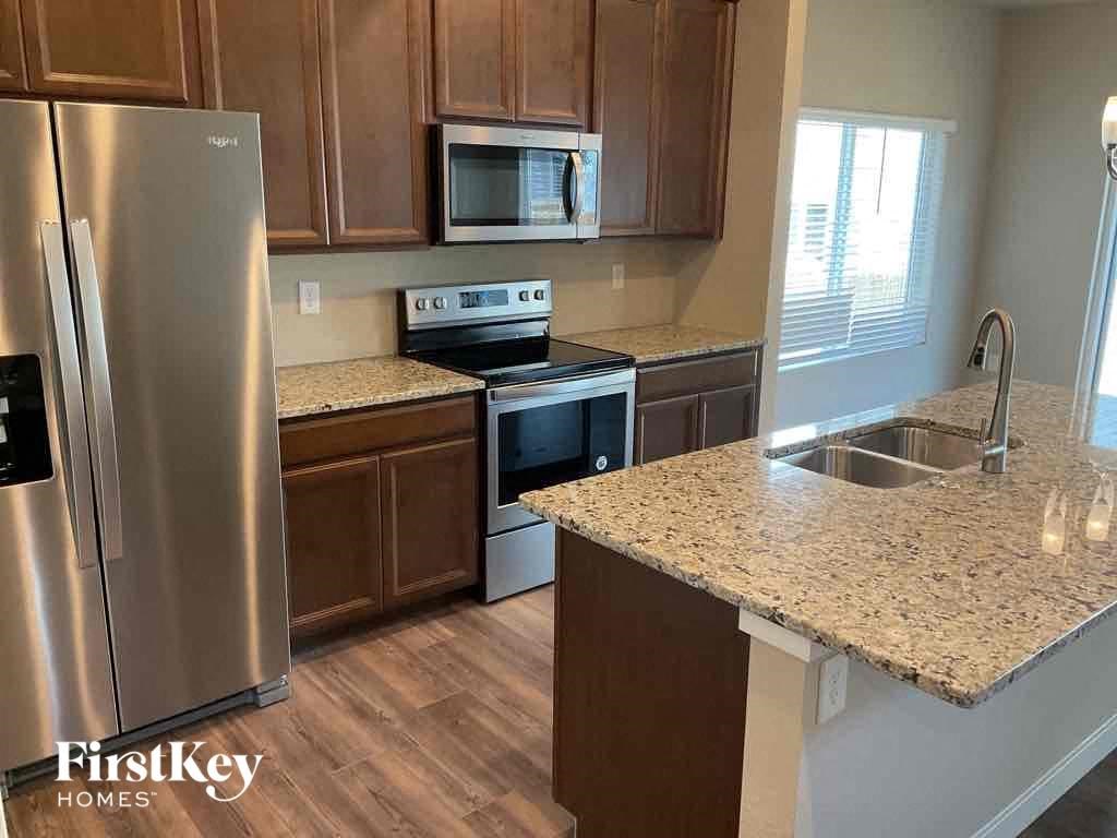 a kitchen with stainless steel appliances and granite counter tops