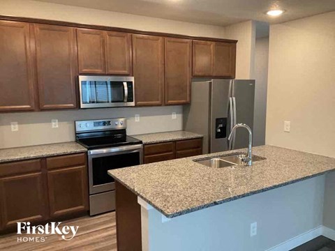a kitchen with granite counter tops and stainless steel appliances