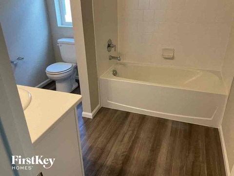a bathroom with a tub and a sink and a toilet
