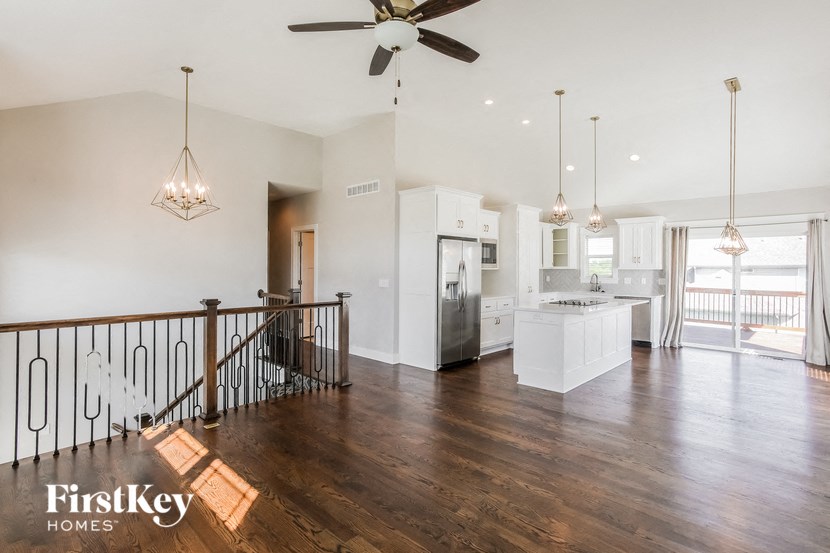 the view of the living room and kitchen from the top of the stairs