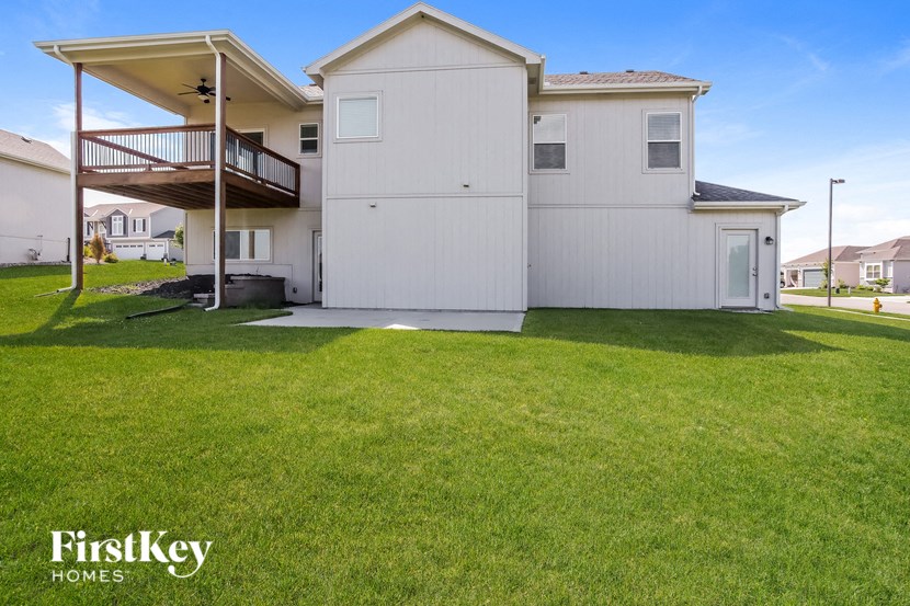 a white house with a lawn in front of it