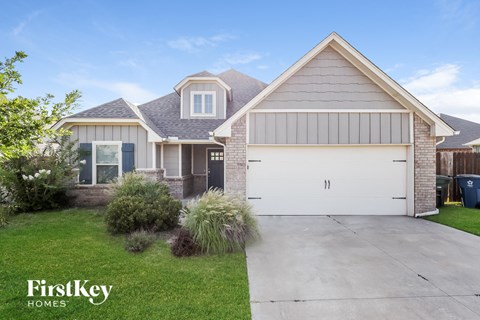 a house with a white garage door and a driveway in front of it