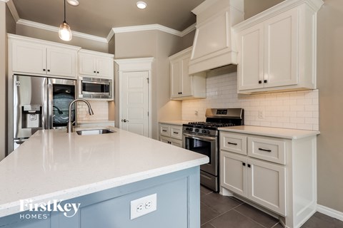 a kitchen with white cabinets and a white counter top