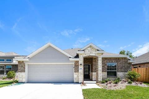 A house with a white garage door and a brown front door.
