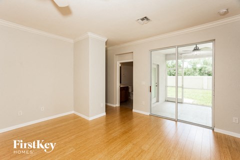 a living room with a wood floor and a sliding glass door