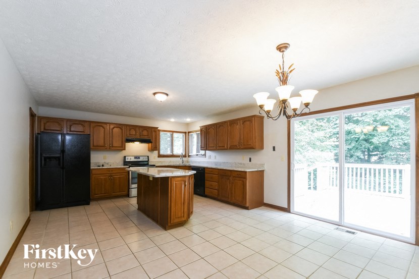 a kitchen with a sliding glass door to a balcony