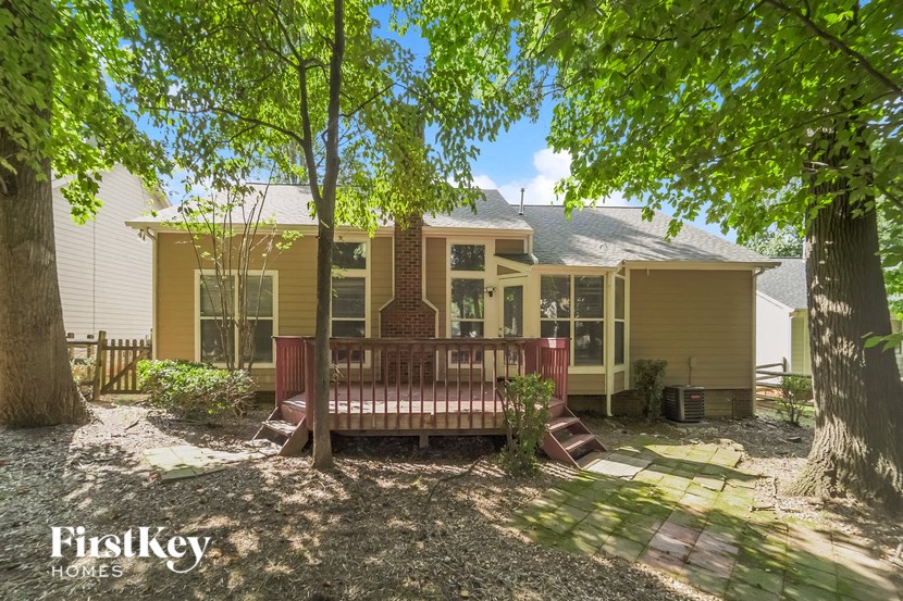 a house with a porch and a wooden bench