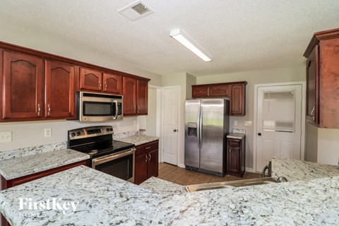 a kitchen with granite counter tops and stainless steel appliances