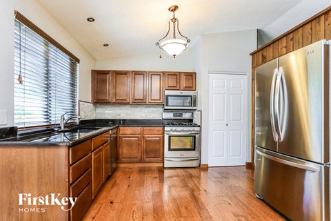 a kitchen with wooden cabinets and stainless steel appliances