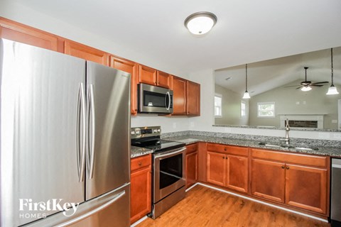 a kitchen with wooden cabinets and stainless steel appliances