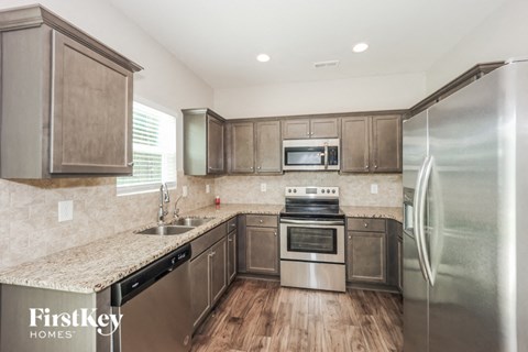 a kitchen with stainless steel appliances and granite counter tops
