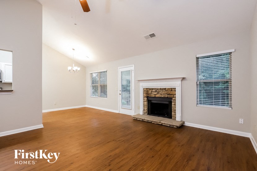 a living room with wood floors and a fireplace