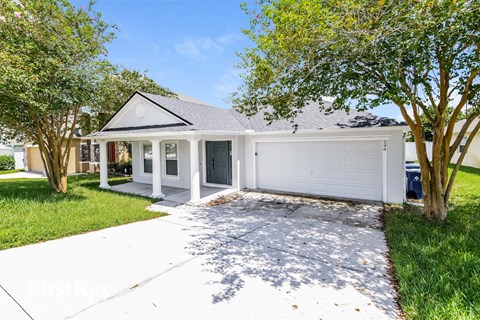 a white house with a driveway and a white garage door