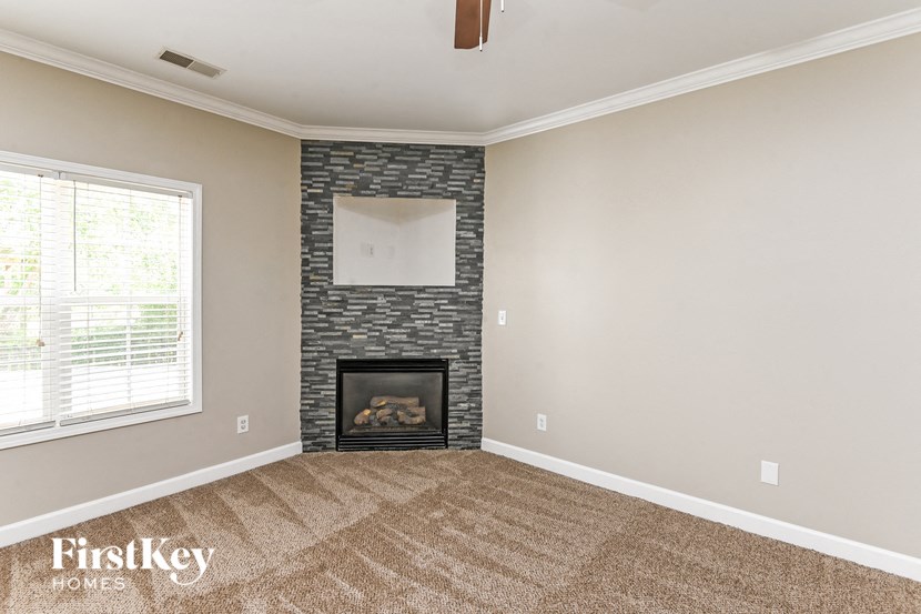 a living room with a fireplace and a window