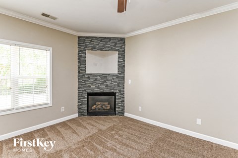 a living room with a fireplace and a window