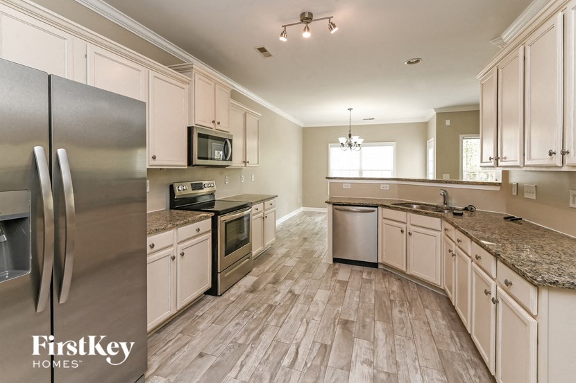 a kitchen with stainless steel appliances and white cabinets