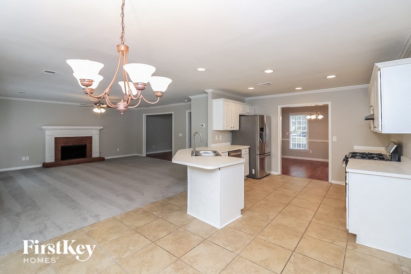 an open kitchen and living room with a fireplace