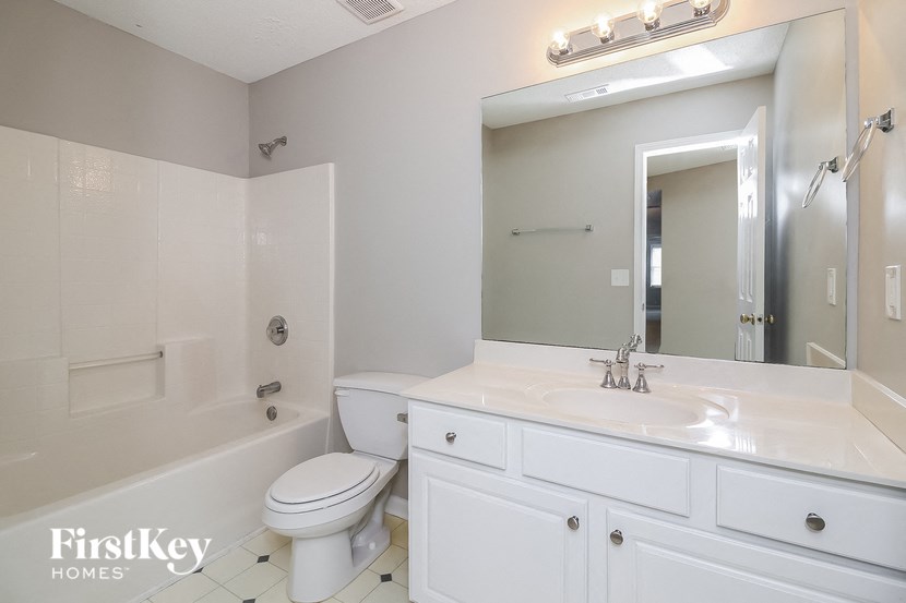 a bathroom with a white sink and a toilet and a shower
