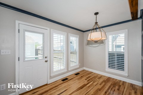 the living room of a home with a wood floor and a white door