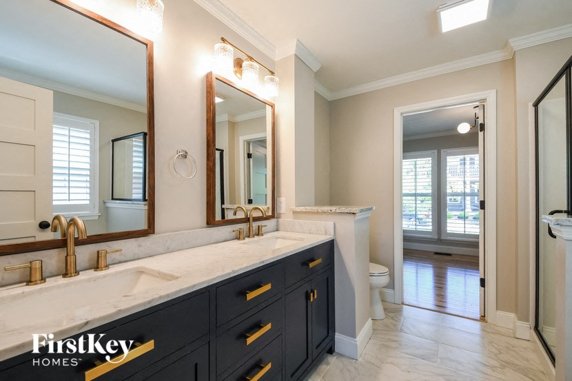 a bathroom with a sink and a mirror and a toilet