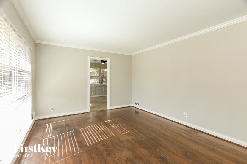A room with wooden floors and a white door.