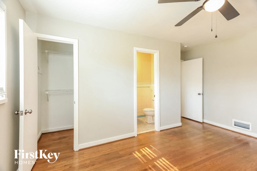 A room with a wooden floor and a ceiling fan.