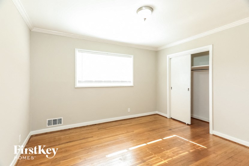 A room with a wooden floor and a window.