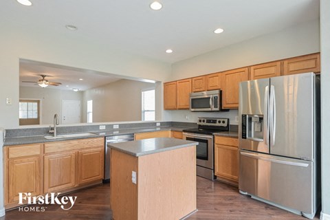 A kitchen with wooden cabinets and stainless steel appliances.