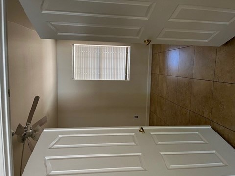 a bathroom with a closet and a window