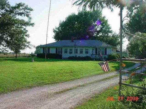 a house with an flag on the side of a road