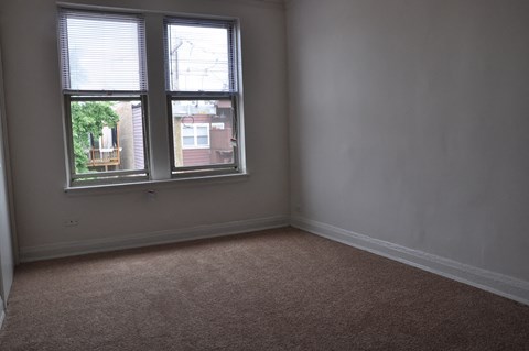 an empty room with two windows in it