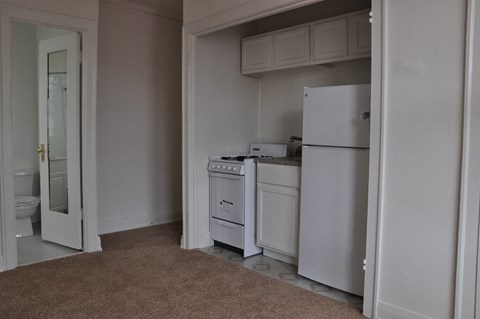 a kitchen with white appliances and a white refrigerator