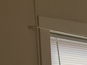 a room with a radiator and a window and a closet