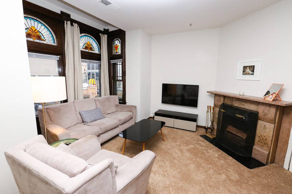 a living room with a couch and a tv and a fireplace