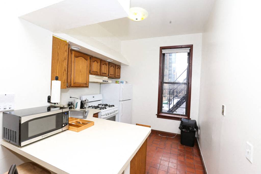a kitchen with a counter top and a microwave