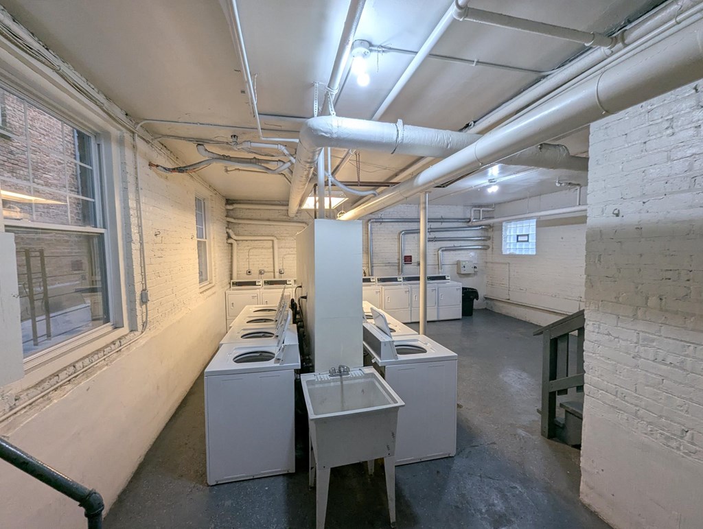 A laundry room with washers and dryers.