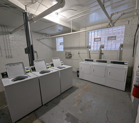 A laundry room with washers and dryers.