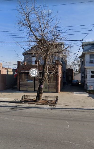 a street with a bench and a tree