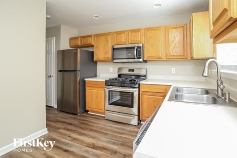 a kitchen with wooden cabinets and stainless steel appliances